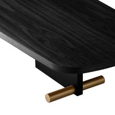 a wooden table with two brass handles on the top and one black wood surface, against a white background