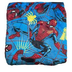 a blue spiderman blanket with yellow and black images on it's back side