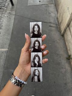 a woman holding up four photos of herself in black and white, with the caption's name on it