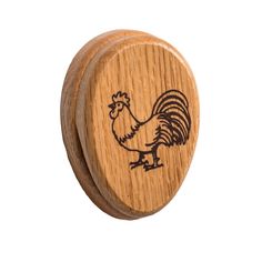 a wooden knob with a rooster engraved on it