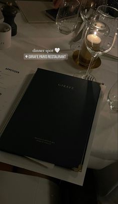 a table with wine glasses and menus on it