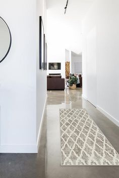 the hallway is clean and ready for us to use as an entrance way in this modern home