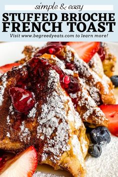 french toast topped with berries and powdered sugar on a white plate next to strawberries