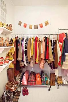 a closet filled with lots of different types of shoes and clothing hanging on the wall