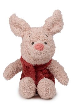 a stuffed animal with a red scarf around it's neck and ears, sitting on a white surface