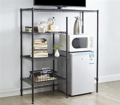 a television is on top of a shelf next to a refrigerator