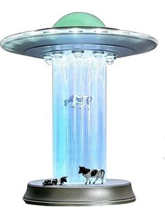 a water fountain with two cows on it and a green dome over the top that is lit up