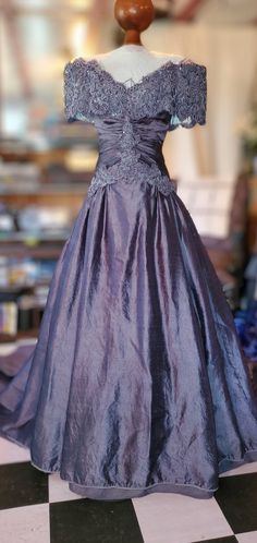 a dress on display in a store window with black and white checkered flooring