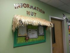 the information hut is decorated with tiki grass and palm that matches it's name