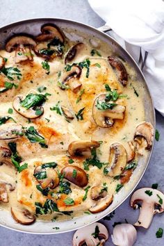 a pan filled with mushrooms and cheese on top of a table