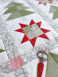 scissors are laying on the edge of a quilt