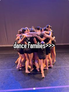 a group of women huddle together in a circle on a stage with the words dance families above them