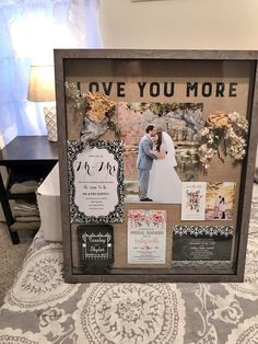 a wedding photo frame with the words love you more on it and photos attached to it