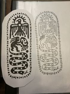 two stencils with designs on them sitting next to each other, one is black and white