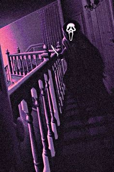 a person in a creepy mask walking down the stairs