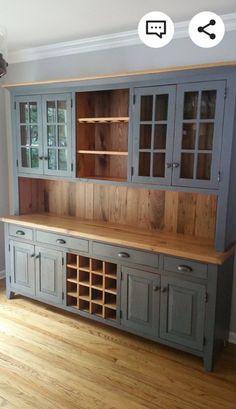 an empty room with wooden floors and cabinets