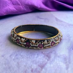 Vintage glittery, sparkly, bangle bracelet. Good condition. Unsigned/unknown maker. Measurements shown in the pics. Thanks for looking! Purple Beaded Bangle Bracelets For Party, Purple Bangle Bracelets For Festivals, Handmade Party Stretch Bangle Bracelet, Handmade Stretch Bangle Bracelet For Party, Festive Beaded Bangle, Festive Beaded Round Bangle, Beaded Bangle For Party, Purple Bracelets For Festivals And Gifts, Adjustable Purple Bangle For Festive Occasions