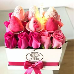 a box filled with pink and red roses