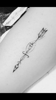 a woman's thigh with an arrow tattoo on it