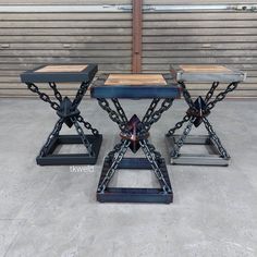 two metal stools with chains on them