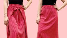 the woman is wearing a red skirt with a bow at the waist and her hands on her hips