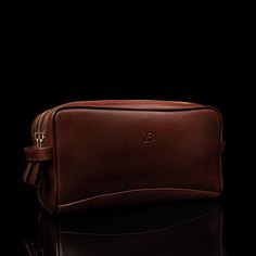 Undeniably masculine, our Superior leather wash bag is a must-have accessory for every man. Its compact yet spacious size and elegant appearance make it perfect both for everyday use and travels alike. Handmade from the finest Italian Cuoio Superiore full-grain vegetable-tanned cow leather this wash bag features a double compartment zipped design and convenient leather strap handles on each end. The spacious interior lined with quality water-repellent nylon canvas will easily accommodate all of Classic Brown Pouch For On-the-go, Classic Everyday Pouch With Leather Lining, Brown Luxury Business Pouch, Luxury Brown Business Pouch, Classic Leather-lined Pouch For Daily Use, Classic Brown Pouch With Leather Lining, Classic Brown Leather-lined Pouch, Classic Rectangular Travel Pouch, Rectangular Travel Pouch With Leather Lining