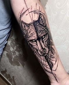 a black and white tattoo on the arm of a man with a wolf head in it