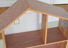 a doll house with wooden floors and brown roof