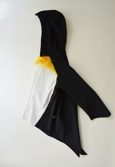 a black, white and yellow scarf laying on top of a table