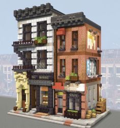 a large building made out of legos on top of a blocky platform with windows and balconies