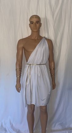 a male mannequin wearing a white dress with gold chains on it's head