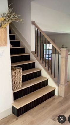 there is a basket on the stairs next to the bannister and another stair case