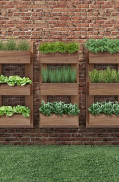 a brick wall with several wooden planters filled with green plants and herbs in them