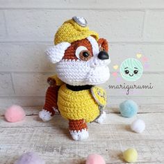 a crocheted stuffed animal wearing a yellow outfit