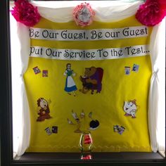 a bulletin board that has been decorated with cartoon characters and words on it, as well as flowers