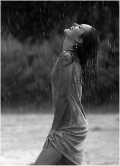 black and white photograph of a woman in the rain with her head tilted to the side