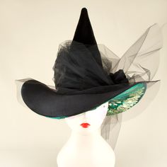 a woman's black hat with mesh netting on the brim and tulle