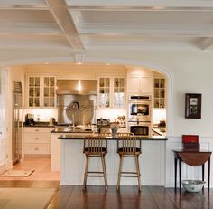 two stools are in front of the kitchen counter