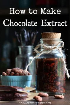 a jar filled with chocolate next to some cookies on a wooden table and the words how to make chocolate extract