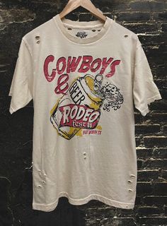 Country Deep Cowboys and Beer Fort Worth Rodeo 1985 Distressed Unisex Tee - Pigment Dyed 40 Singles Jersey 100% Cotton Premium quality ringspun and compacted cotton Fine Cotton Jersey that is pigment dyed for a more vintage look Features tears and destroyed features at neck and on body Each piece is unique as this process is done by hand! 3.8 oz Made In USA Every garment dye item can be a slightly different shade in color since this is a laundry dye process. Enjoy its unique quality! SIZE CHART