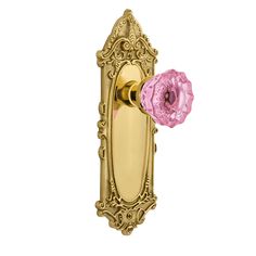 a pink and gold door handle with a flower on it