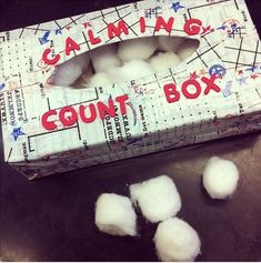 a box filled with cotton balls sitting on top of a table