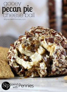 a close up of a ball of food on a plate with crackers in the background