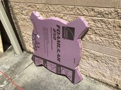 a cardboard cutout of a pig on the side of a building