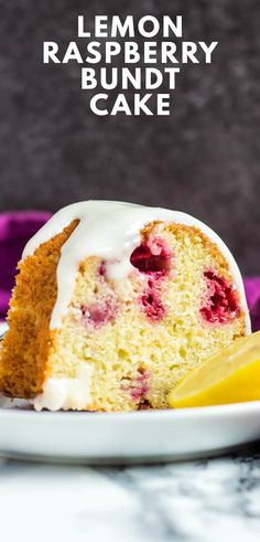 a slice of cake with white icing and raspberry topping on a plate