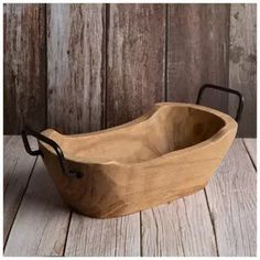 a wooden bowl sitting on top of a table