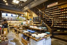 the inside of a restaurant with lots of plates and bowls on display in front of it