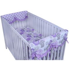 a white crib with purple flowers on it