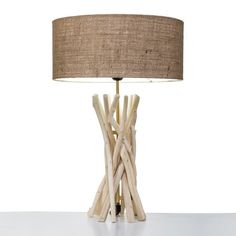 a table lamp made out of sticks and a light shade on top of the base