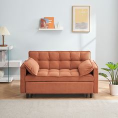 a living room with a couch, lamp and pictures on the wall